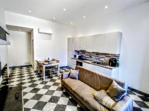 a living room with a couch and a table at - The Marble Theater- [Carrara Centro] in Carrara
