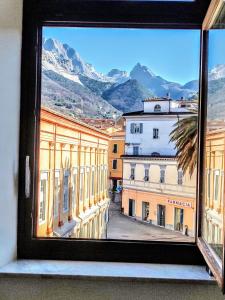 a view from a window of a city with mountains at - The Marble Theater- [Carrara Centro] in Carrara