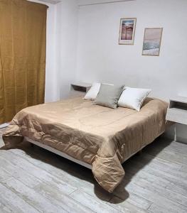 Un pat sau paturi într-o cameră la Piñeyro