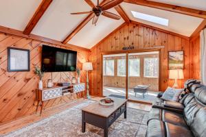 a living room with a couch and a tv at Inviting Alton Bay Home Near Lake Winnipesaukee! in Alton Bay