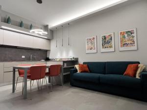 a living room with a blue couch and a table at Luxury Basilica View 19 - free private parking in Genoa