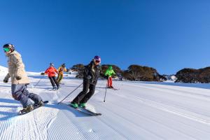 a group of people on skis in the snow at Lucy Lodge in Charlotte Pass