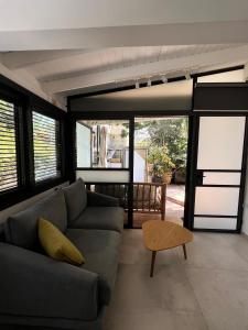 a living room with a couch and a table at Saloniky Garden in H̱olon
