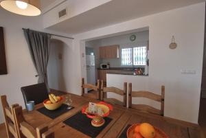 una cocina y comedor con una mesa con fruta. en Villa Luna en Catral
