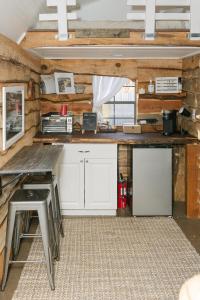 a kitchen with white cabinets and a counter top at Blythe Shoals Base Camp in Cleveland +28 photos