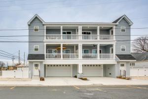a large gray house with two garages at The Kraken Wildwood Townhome half Mi to Beach! in Wildwood