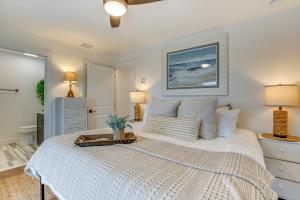 a bedroom with a white bed with a tray on it at The Kraken Wildwood Townhome half Mi to Beach! in Wildwood
