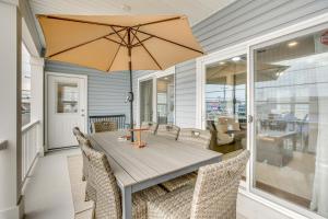 a dining room with a table with an umbrella at The Kraken Wildwood Townhome half Mi to Beach! in Wildwood