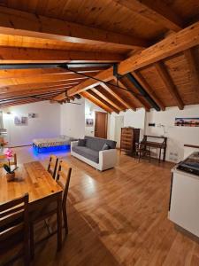 a large living room with a table and a couch at The view Lake ,Appartamento Blevio Fronte lago Como in Blevio