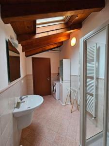 a bathroom with a sink and a washing machine at The view Lake ,Appartamento Blevio Fronte lago Como in Blevio