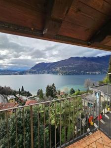 a view of a lake from the balcony of a house at The view Lake ,Appartamento Blevio Fronte lago Como in Blevio +28 photos