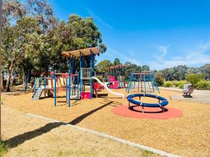 a park with a playground with a slide at House in Thomastown in Melbourne