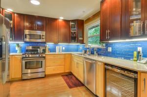 a kitchen with wooden cabinets and stainless steel appliances at Bonne Chere in Guerneville
