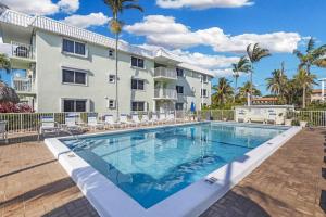 a swimming pool in front of a building at Paradise awaits you at Key Colony Beach in Key Colony Beach