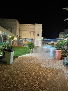 a large white building at night with at شالية الفوز in Al Madinah