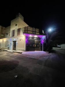 a building with purple lights on the side of it at شالية الفوز in Medina