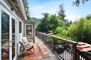 a balcony with two chairs and a table at The Boat House in Guerneville