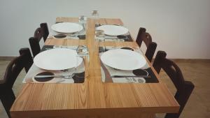 a long wooden table with four chairs around it at Duplex Atenea in Chivilcoy