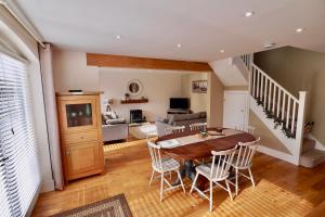 a dining room and living room with a table and chairs at Oak Tree Barn in Pickering