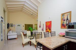 a kitchen and living room with a table and chairs at Ocho Rios Drax Hall Manor 3 Bed Getaway in Mammee Bay