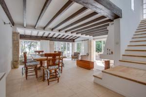 a dining room with a table and chairs at Villa Cala Padri Seafront home in Capdepera