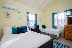a bedroom with two beds and a dresser at Ocho Rios Drax Hall Manor 3 Bed Getaway in Mammee Bay