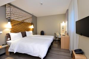 Ein Bett oder Betten in einem Zimmer der Unterkunft Ibis Muenchen City Ost