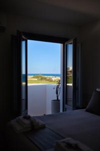 Un dormitorio con una cama con vista al mar. en Cala Sala Suite Sun & Sea, en Polignano a Mare