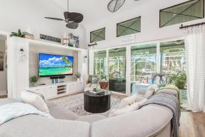 a living room with two couches and a tv at Perfect Blend of Elegance and Comfort I Captivating Home For Idyllic Retreat in Marco Island