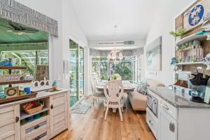 a kitchen with a table and a dining room at Perfect Blend of Elegance and Comfort I Captivating Home For Idyllic Retreat in Marco Island