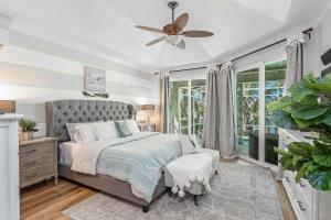 a bedroom with a bed and a ceiling fan at Perfect Blend of Elegance and Comfort I Captivating Home For Idyllic Retreat in Marco Island +23 photos