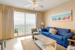 un soggiorno con divano blu e balcone di Splash Resort 2002W a Panama City Beach