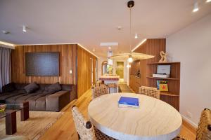 a living room with a table and a couch at Burleigh Beach Tower in Gold Coast