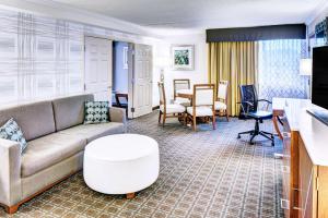 a living room with a couch and a table at DoubleTree by Hilton Madison Downtown in Madison