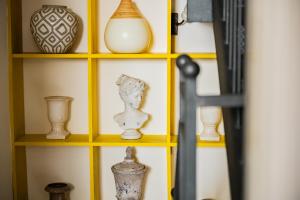a shelf with vases and other items on it at Cascabella Taormina in Taormina