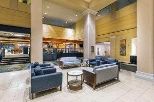 a lobby of a hotel with couches and chairs at DoubleTree by Hilton Tulsa Downtown in Tulsa