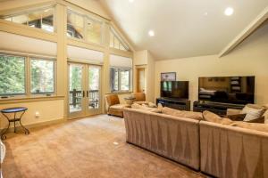 a living room with a large couch and a television at Family Home, Hot Tub, Suncadia Pool Access in Cle Elum