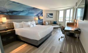 a hotel room with a bed and a desk and a computer at Coast Bastion Hotel in Nanaimo
