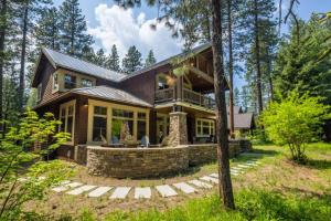 a house in the woods with a wrap around porch at Family Home, Hot Tub, Suncadia Pool Access in Cle Elum