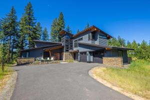 ein Haus auf einem Hügel mit Auffahrt in der Unterkunft Suncadia 5 Bdrm Home Nestled in the Forest in Cle Elum