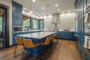 a kitchen with a large blue island with stools at Suncadia 5 Bdrm Home Nestled in the Forest in Cle Elum