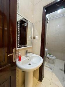 a bathroom with a sink and a toilet at شاليه الفوز 2 in Al Madinah