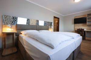 Postel nebo postele na pokoji v ubytování Arthotel ANA Flair