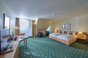 a hotel room with a bed and a desk at Balance Hotel Leipzig Alte Messe in Leipzig +32 photos