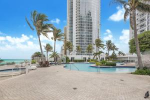 a resort with a swimming pool and a tall building at 15th Floor Luxury Suite at Trump Int Resort in Sunny Isles Beach