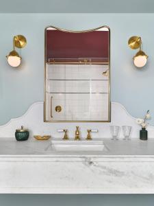 a bathroom with a sink and a mirror at The Hotel Chalet at The Choo Choo in Chattanooga