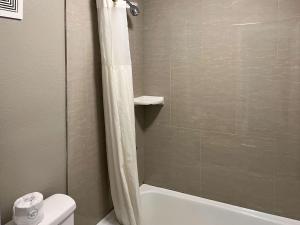 a bathroom with a shower and a toilet at Motel 6 Montgomery, AL - Eastern Blvd. in Montgomery