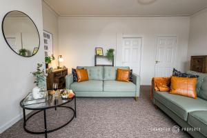 uma sala de estar com um sofá e uma mesa em New! Stylish 2 bed flat with parking near beach - Parkstone Central em Parkstone