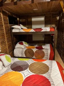 Postel nebo postele na pokoji v ubytování Hotel Campestre Cabañas de la Sierra Nevada de El Cocuy