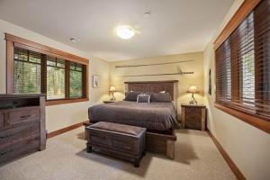 a bedroom with a bed and a dresser and windows at Suncadia 4 Bdrm Home with Private Hot Tub in Cle Elum +29 photos